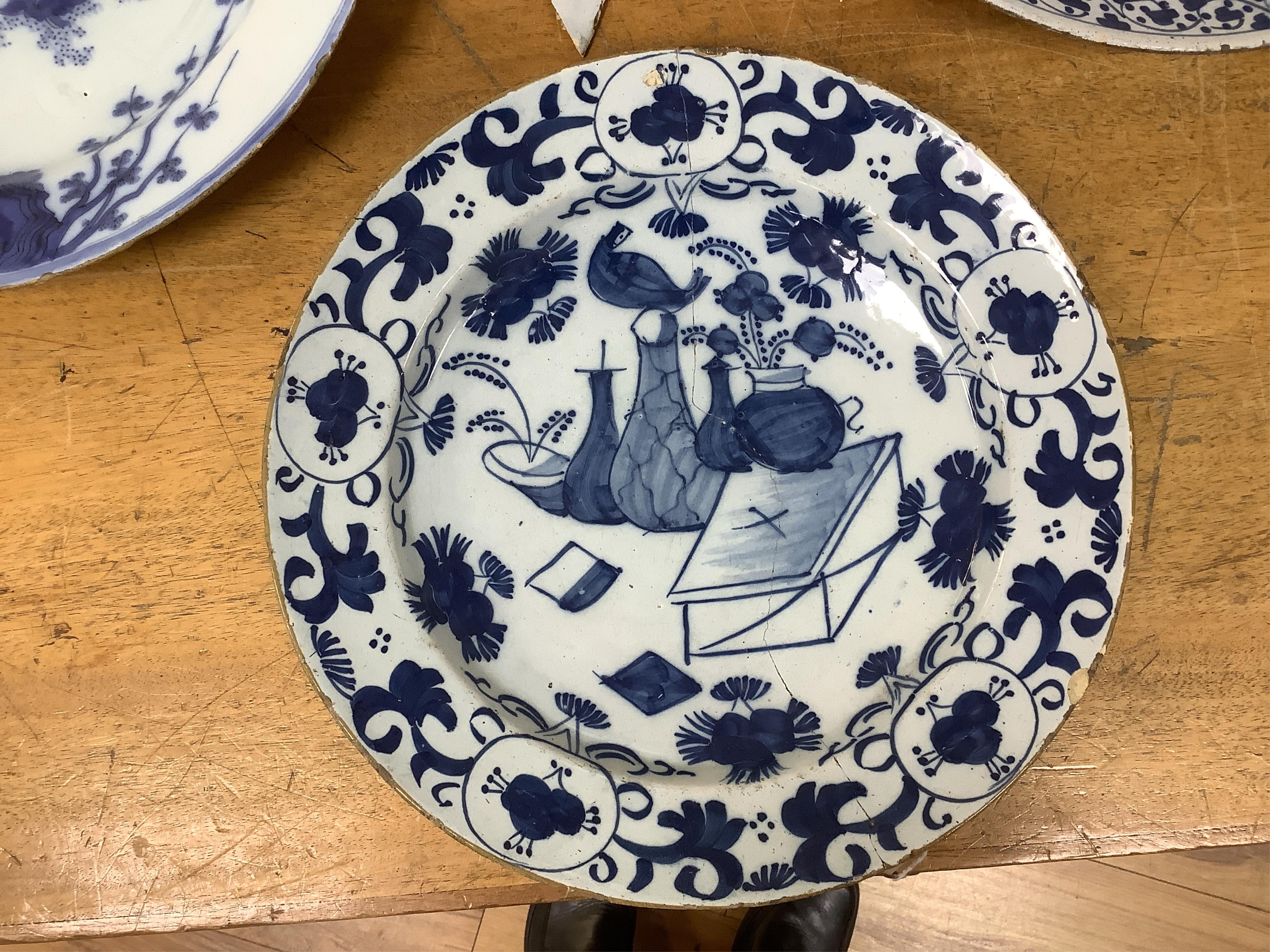 An 18th century English delftware ‘Chinese figures’ dish and two similar Delft dishes, largest 39cm diameter (3), largest 39cm